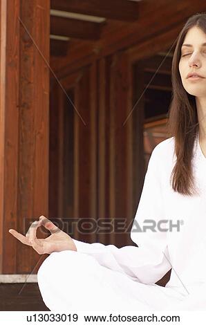 Stock Photo - Woman meditating, cropped, portrait. Fotosearch