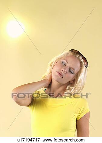 Woman rubbing back of neck on hot Summer Day View Large Photo Image Stock Photo - Woman rubbing back of neck on hot Summer Day. Fotosearch