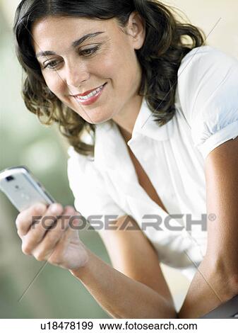 Woman sending text message View Large Photo Image Stock Photo - Woman sending text message. Fotosearch