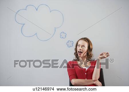 Woman sitting in front of graphic on whiteboard View Large Photo Image Picture - Woman sitting in front of graphic on whiteboard. Fotosearch