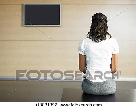 Woman sitting on bench in lobby using laptop View Large Photo Image Stock Image - Woman sitting on bench in lobby using laptop. Fotosearch