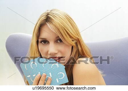 Stock Image - Woman sitting Playing Cards, portrait. Fotosearch