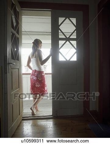 Woman standing in open door, Looking Out, back view View Large Photo Image Stock Image - Woman standing in open door, Looking Out, back view. Fotosearch