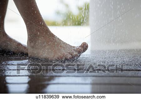 Woman standing under outdoor shower, close up of feet, low section, View Large Photo Image Stock Photo - Woman standing under outdoor shower, close up of feet, low section, . Fotosearch