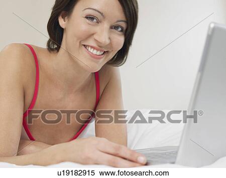 Woman Using Laptop on Bed View Large Photo Image Stock Photography - Woman Using Laptop on Bed. Fotosearch
