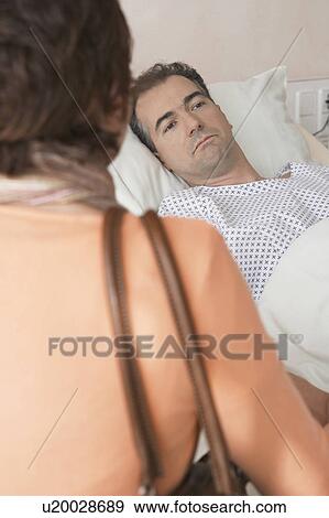 Woman Visiting Husband in Hospital, over the shoulder View Large Photo Image Stock Photo - Woman Visiting Husband in Hospital, over the shoulder. Fotosearch