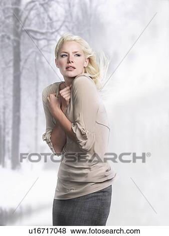 Woman with hair blowing, arms crossed, side view View Large Photo Image Stock Photo - Woman with hair blowing, arms crossed, side view. Fotosearch