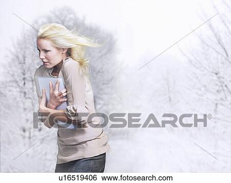 Woman with hair blowing, facing into wind, side view View Large Photo Image Stock Photograph - Woman with hair blowing, facing into wind, side view. Fotosearch