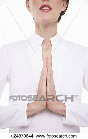 Picture - Woman with hands together praying, head and shoulders. Fotosearch