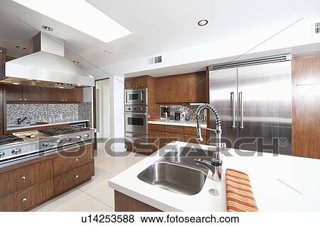 Stock Photo - Wood and stainless steel kitchen. Fotosearch