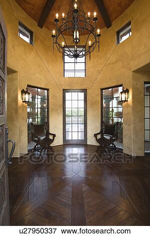 Wood floored vestibule with candelabra hanging from high ceiling View Large Photo Image Stock Photo - Wood floored vestibule with candelabra hanging from high ceiling. Fotosearch