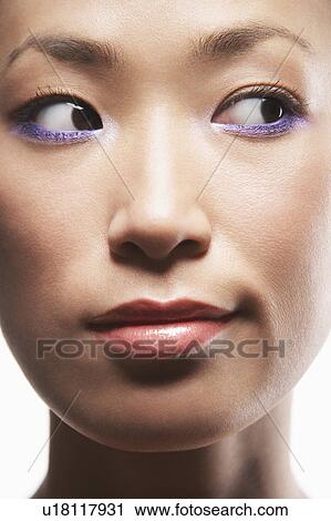 Stock Image - Young Asian woman looking to side. Fotosearch