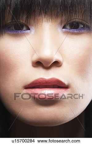 Picture - Young Asian woman's face with fringe. Fotosearch