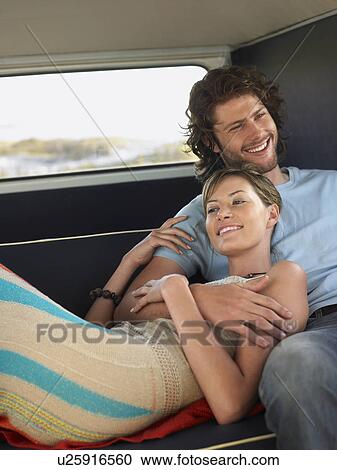 Young couple embracing in back of van View Large Photo Image Stock Image - Young couple embracing in back of van. Fotosearch