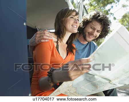 Young Couple Reading Map on Road Trip View Large Photo Image Stock Photo - Young Couple Reading Map on Road Trip. Fotosearch