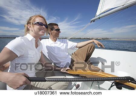Young couple relax on deck of sailing boat View Large Photo Image Stock Image - Young couple relax on deck of sailing boat. Fotosearch