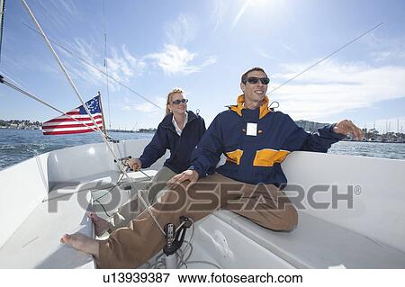 Young couple relax on deck of sailing boat View Large Photo Image Stock Photo - Young couple relax on deck of sailing boat. Fotosearch