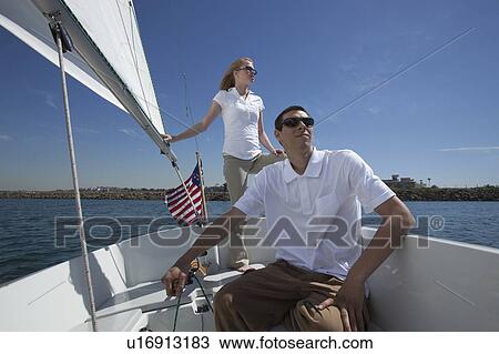 Stock Image - Young couple sailing. Fotosearch