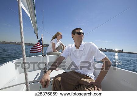 Stock Photo - Young couple sailing. Fotosearch