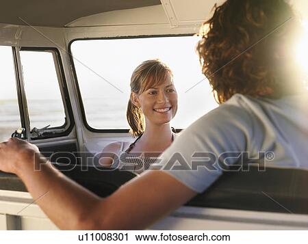 Young couple sitting in van, head and shoulders View Large Photo Image Stock Image - Young couple sitting in van, head and shoulders. Fotosearch