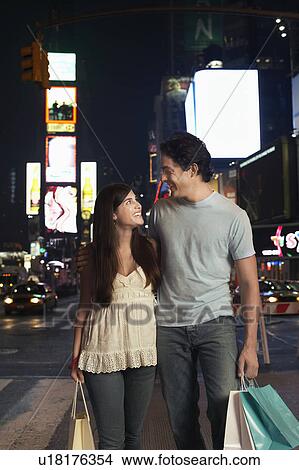 Picture - Young Couple Walking on City Street At Nighttimes. Fotosearch