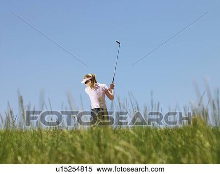 Young female golfer driving ball, back view View Large Photo Image Stock Photography - Young female golfer driving ball, back view. Fotosearch