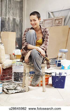 Young female Painter sitting in work site with equipment, portrait View Large Photo Image Stock Image - Young female Painter sitting in work site with equipment, portrait. Fotosearch