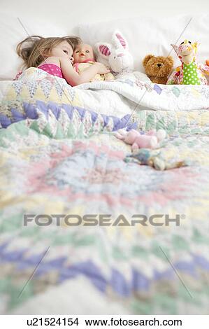 Young girl, 2-3 years with cuddly toys in bed View Large Photo Image Picture - Young girl, 2-3 years with cuddly toys in bed. Fotosearch