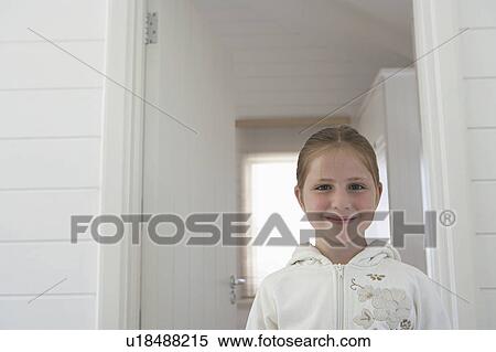Young girl standing inside, head and shoulders, portrait View Large Photo Image Stock Photography - Young girl standing inside, head and shoulders, portrait. Fotosearch