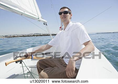Young man sailing View Large Photo Image Stock Image - Young man sailing. Fotosearch