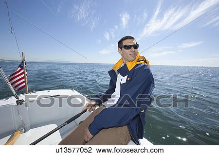 Young man sailing View Large Photo Image Stock Image - Young man sailing. Fotosearch