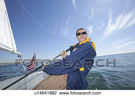 Young man sailing View Large Photo Image Stock Image - Young man sailing. Fotosearch
