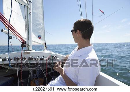 Young man sailing View Large Photo Image Stock Image - Young man sailing. Fotosearch