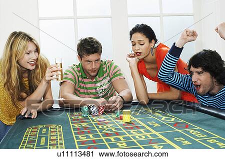 Young man winning on roulette table while friends lose View Large Photo Image Stock Image - Young man winning on roulette table while friends lose. Fotosearch