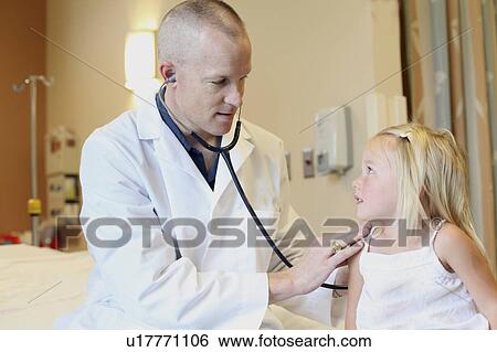 Young pediatrician listens to young girl's breathing View Large Photo Image Stock Photograph - Young pediatrician listens to young girl's breathing. Fotosearch