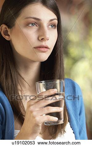 Young woman drinking glass of water, portrait View Large Photo Image Stock Image - Young woman drinking glass of water, portrait. Fotosearch