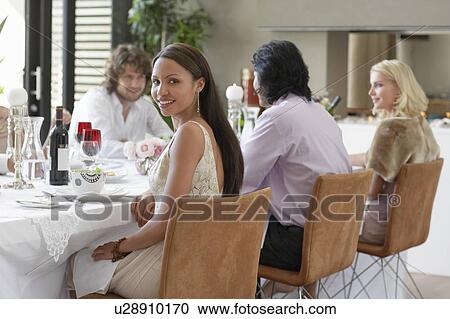Young woman in dress sitting at table of formal dinner party View Large Photo Image Stock Image - Young woman in dress sitting at table of formal dinner party. Fotosearch