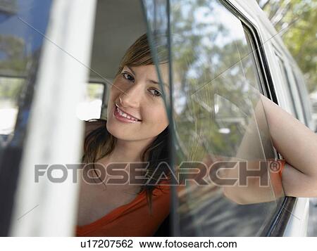 Young Woman looking through van window, half length View Large Photo Image Stock Image - Young Woman looking through van window, half length. Fotosearch