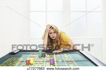 Young woman losing on roulette table View Large Photo Image Stock Image - Young woman losing on roulette table. Fotosearch