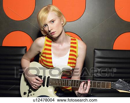 Young woman playing guitar, portrait View Large Photo Image Picture - Young woman playing guitar, portrait. Fotosearch
