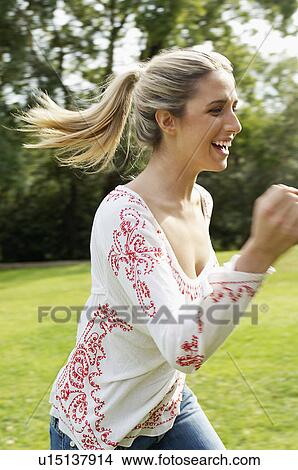 Young woman running, portrait View Large Photo Image Picture - Young woman running, portrait. Fotosearch