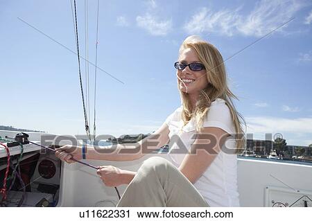 Stock Image - Young woman sailing. Fotosearch