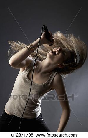 Young woman singing in studio View Large Photo Image Stock Photo - Young woman singing in studio. Fotosearch