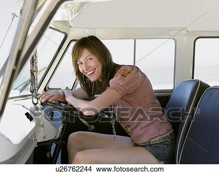 Young woman smiling in drivers seat of van View Large Photo Image Picture - Young woman smiling in drivers seat of van. Fotosearch