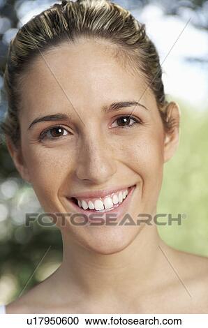 Stock Image - Young woman smiling, portrait. Fotosearch