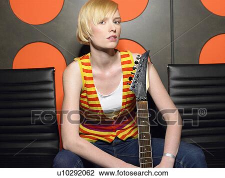 Young woman with guitar, portrait View Large Photo Image Stock Image - Young woman with guitar, portrait. Fotosearch