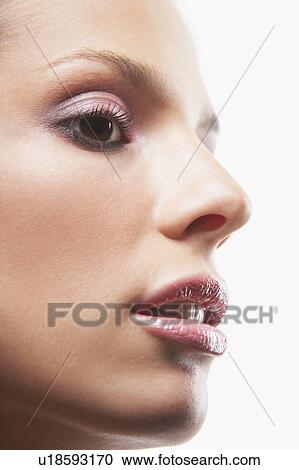 Stock Image - Young woman's face, with make-up. Fotosearch