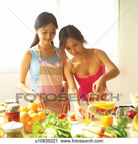 Stock Image - Asian Ethnicity, Body Care, Cheerful, Drinking, Tomato, Young Women, Adults Only. Fotosearch