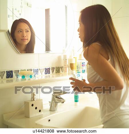 Stock Photo - Bathroom, Casual Clothing, Brown Hair, Asian Ethnicity. Fotosearch