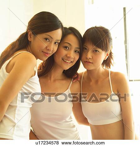 Stock Photo - Brown Hair, Young Adult, Sports Bra, Side By Side, Body Conscious, Togetherness. Fotosearch
